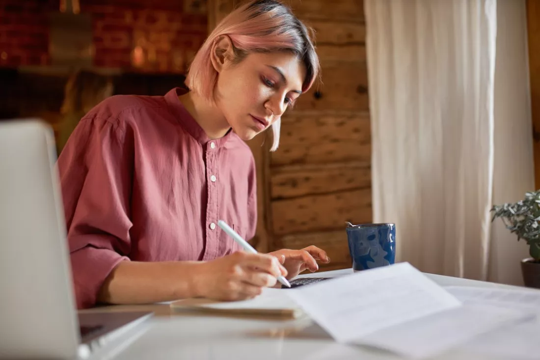 A student writing her CV