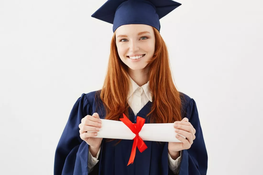 A young graduate holding her diploma